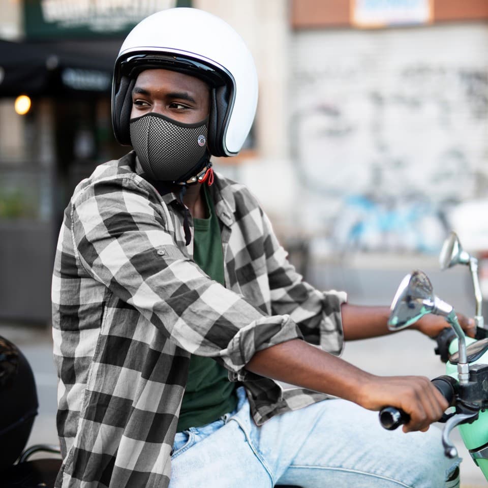 Young guy on a bike with Frogmask motorcyclist pollution mask